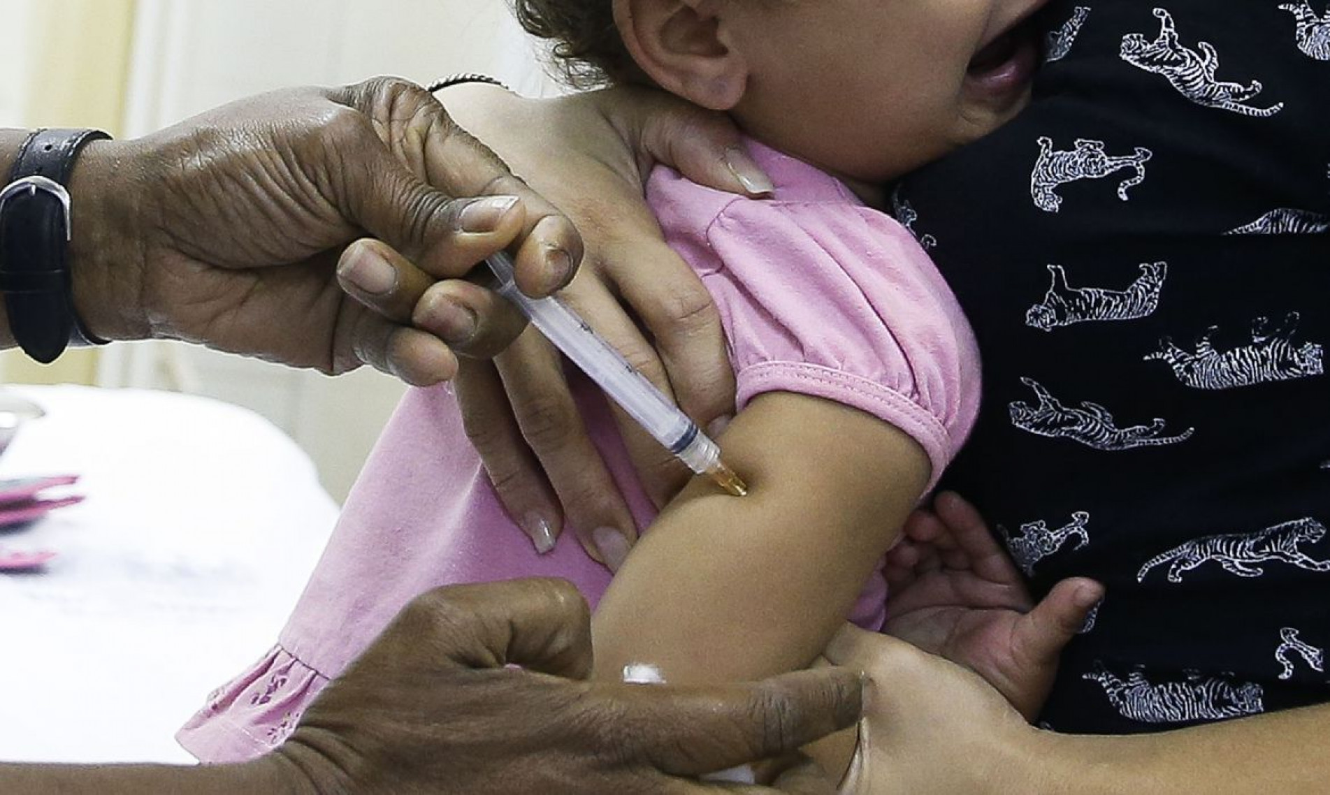  Crian..as com idade entre 1 ano e menores de 5 s..o vacinadas no posto de sa..de Heitor Beltr..o, na Tijuca, zona norte do Rio, para receber a dose contra a p..lio e contra o sarampo. 
    