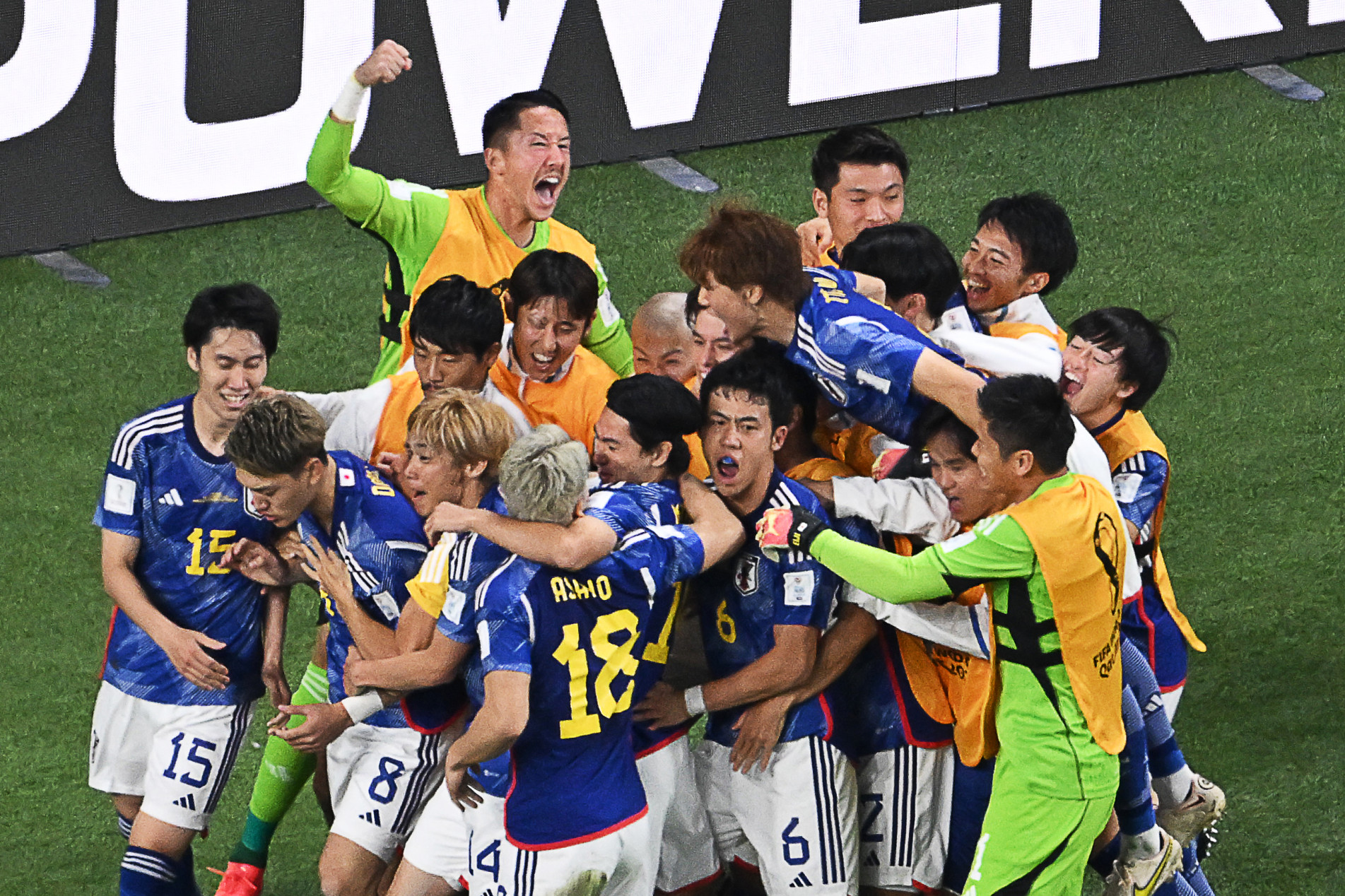  Japan's players celebrate their first goal during the Qatar 2022 World Cup Group E football match between Germany and Japan at the Khalifa International Stadium in Doha on November 23, 2022. (Photo by Antonin THUILLIER / AFP)