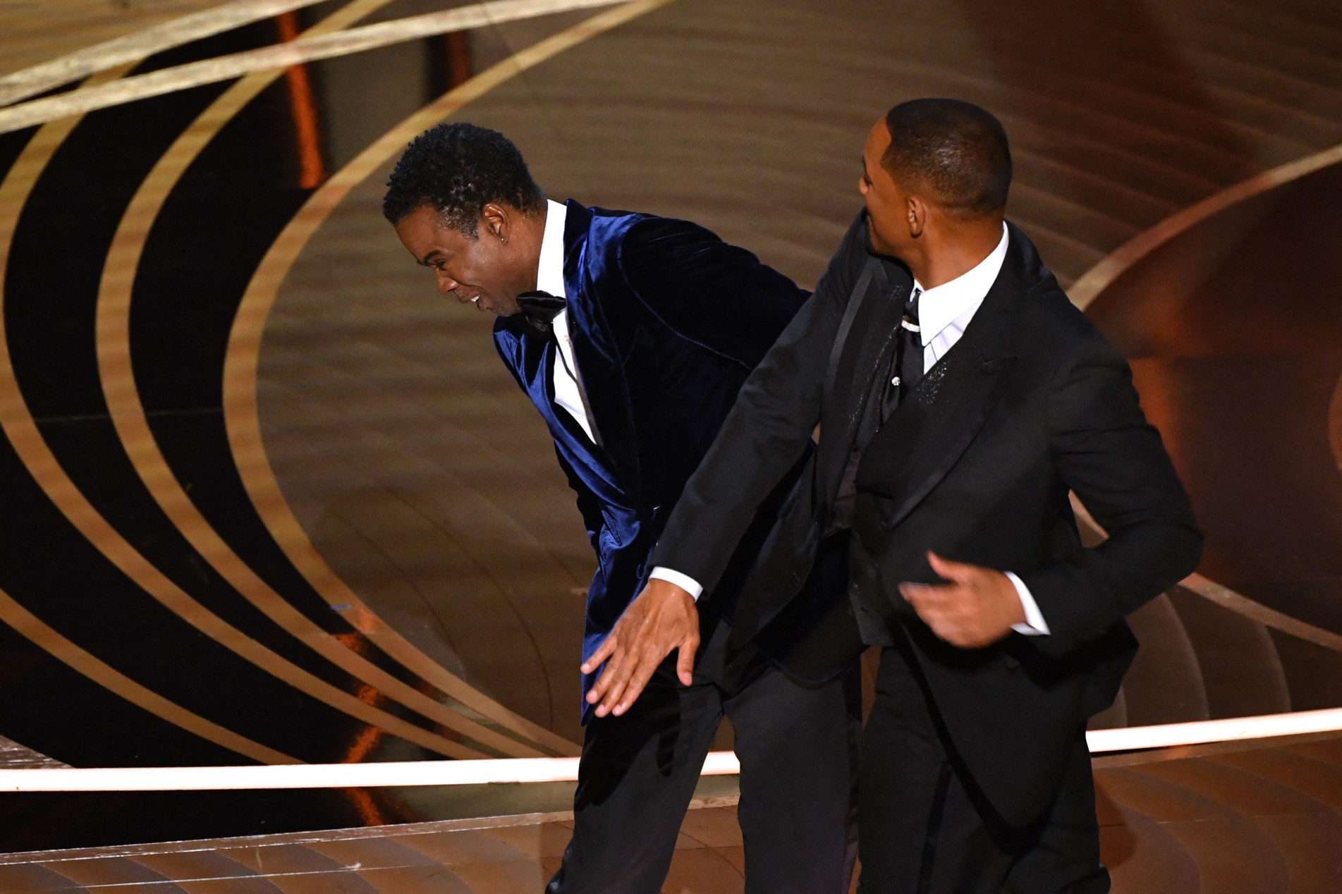  -- AFP PICTURES OF THE YEAR 2022 --
US actor Will Smith (R) slaps US actor Chris Rock onstage during the 94th Oscars at the Dolby Theatre in Hollywood, California on March 27, 2022.  AFP PICTURES OF THE YEAR 2022
 (Photo by Robyn Beck / AFP) / AFP PICTURES OF THE YEAR 2022