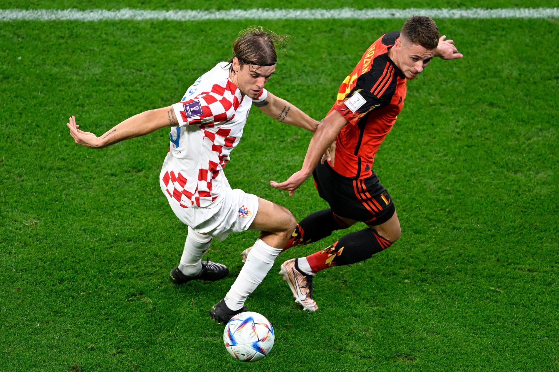  Croatia's defender #19 Borna Sosa (L) fights for the ball with Belgium's midfielder #16 Thorgan Hazard during the Qatar 2022 World Cup Group F football match between Croatia and Belgium at the Ahmad Bin Ali Stadium in Al-Rayyan, west of Doha on December 1, 2022. (Photo by Alfredo ESTRELLA / AFP)