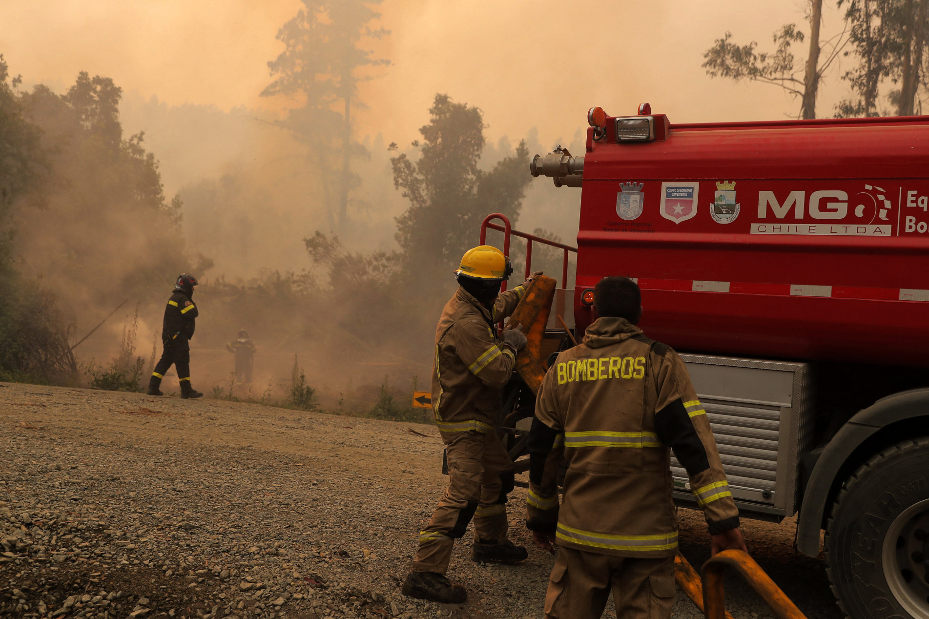  Firefighters try to extinguish the forest fire in Santa Juana, Concepcion province, Chile on February 6, 2023. - The fires, which have been raging since last week, have left 26 people dead, 1,260 injured, 3,000 homeless and 1,159 homes burned, according to a report released by the National Service of Disasters Prevention and Response (Senapred). (Photo by JAVIER TORRES / AFP)
      Caption