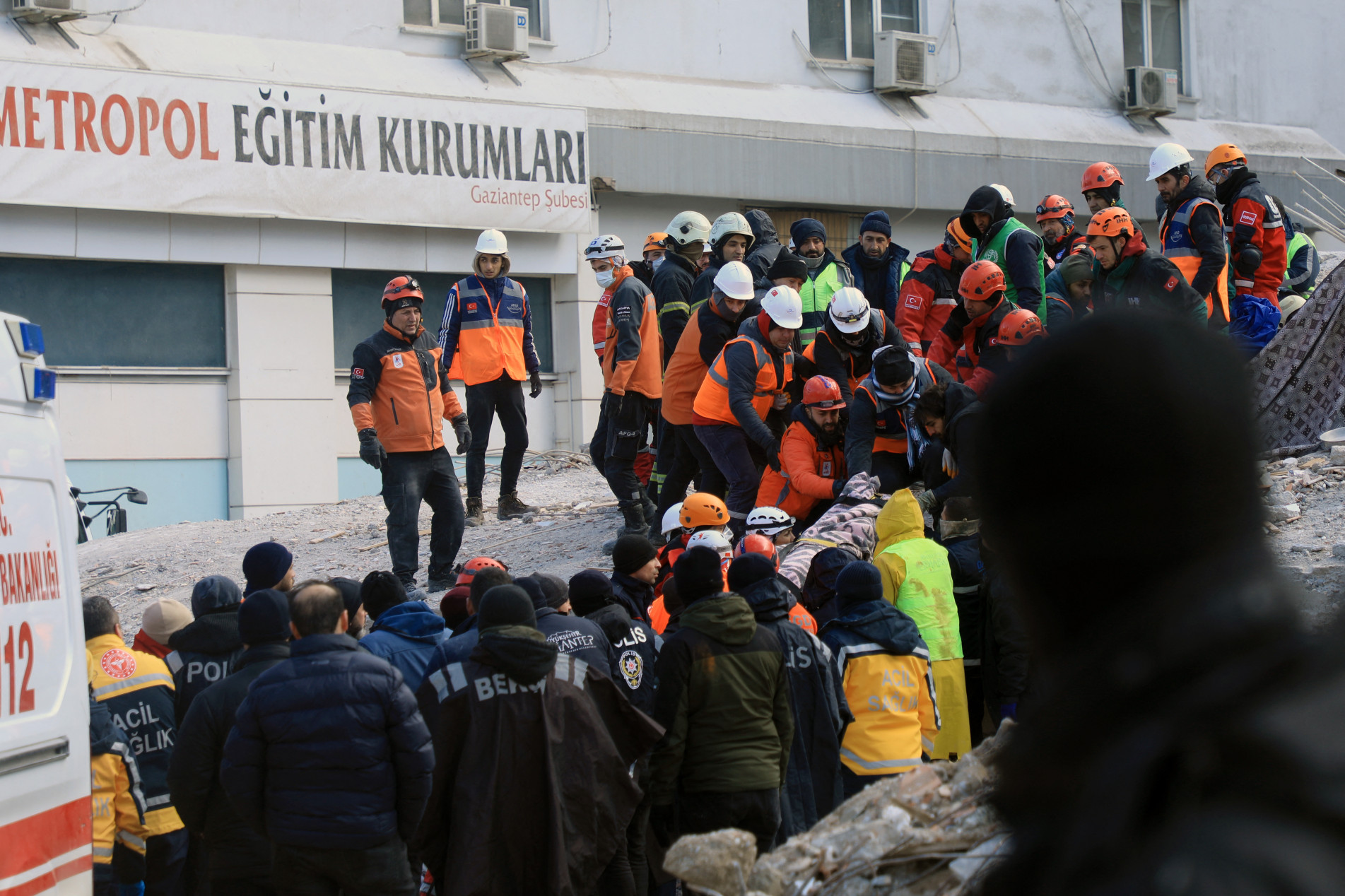  Rescuers evacuate a victim retrieved in the rubble of collapsed buldings in Gaziantep, close to the quake's epicentre, a day after a 7.8-magnitude earthquake struck the country's southeast, on February 7, 2023. - Rescuers in Turkey and Syria braved frigid weather, aftershocks and collapsing buildings, as they dug for survivors buried by an earthquake that killed more than 5,000 people. Some of the heaviest devastation occurred near the quake's epicentre between Kahramanmaras and Gaziantep, a city of two million where entire blocks now lie in ruins under gathering snow. (Photo by Zein Al RIFAI / AFP)