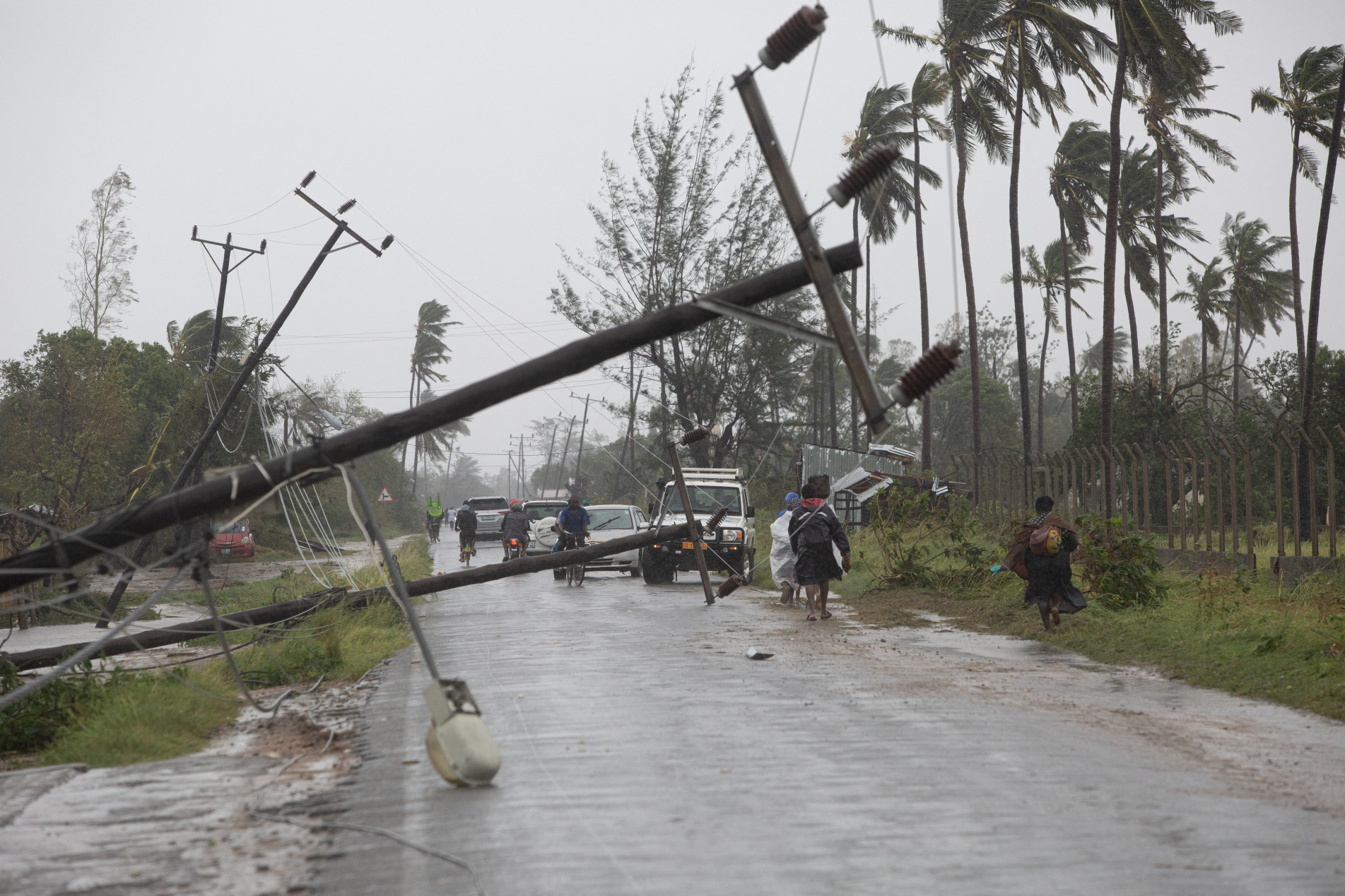  This handout photograph taken and distributed by UNICEF on March 12, 2023 shows people walking along a street damaged by the impact of Cyclone Freddy in the city of Quelimane. - Tropical cyclone Freddy, which made landfall in Mozambique overnight from March 11, 2023 to March 12, 2023 for the second time in two weeks, killed at least one person on its return and displaced dozens, according to an initial report from local authorities on March 12, 2023.
Freddy had already killed 10 people in the southern African country during his first visit at the end of February and 17 in total in Madagascar where he also struck twice, describing a looping trajectory rarely known to meteorologists. (Photo by Alfredo ZUNIGA / UNICEF / AFP) / RESTRICTED TO EDITORIAL USE - MANDATORY CREDIT 