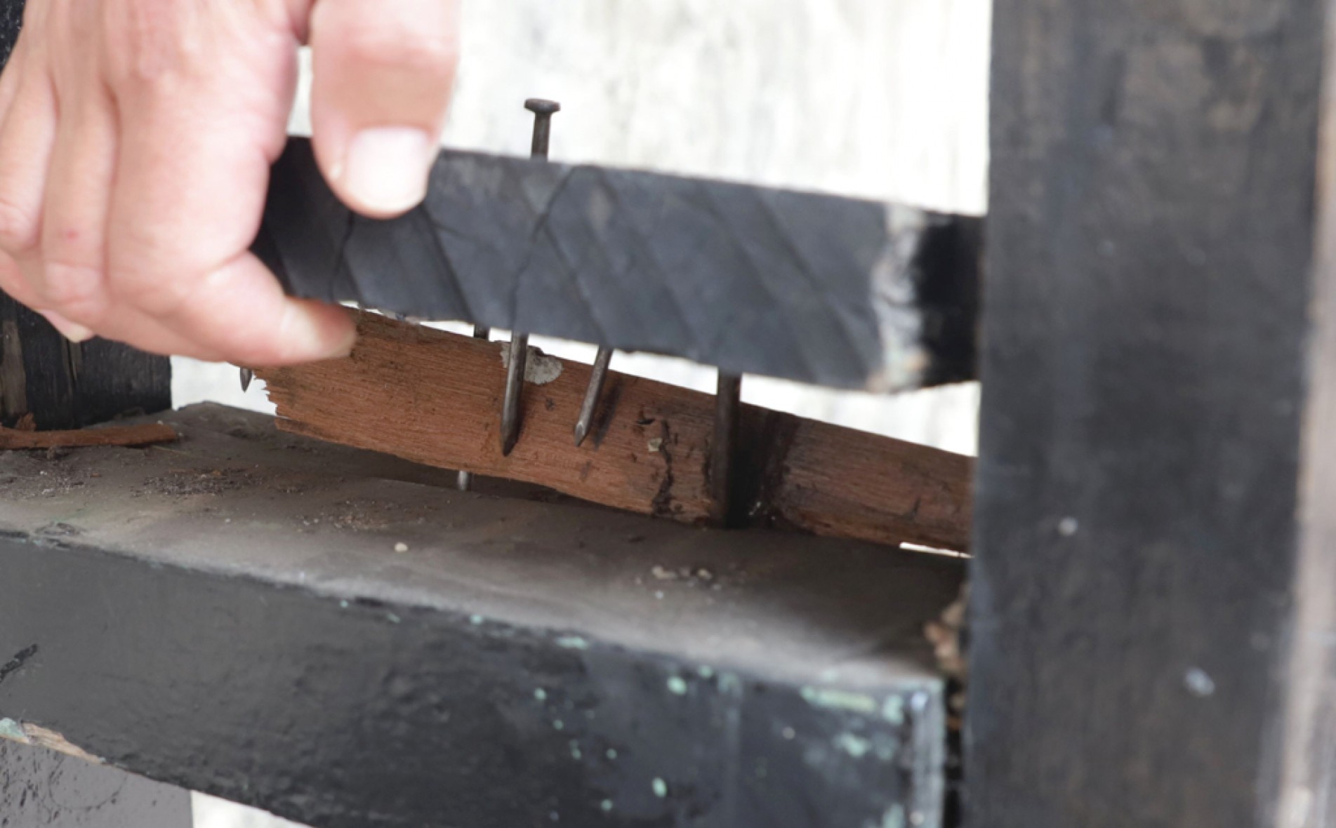 Um dos bancos está solto e com os pregos aparentes
