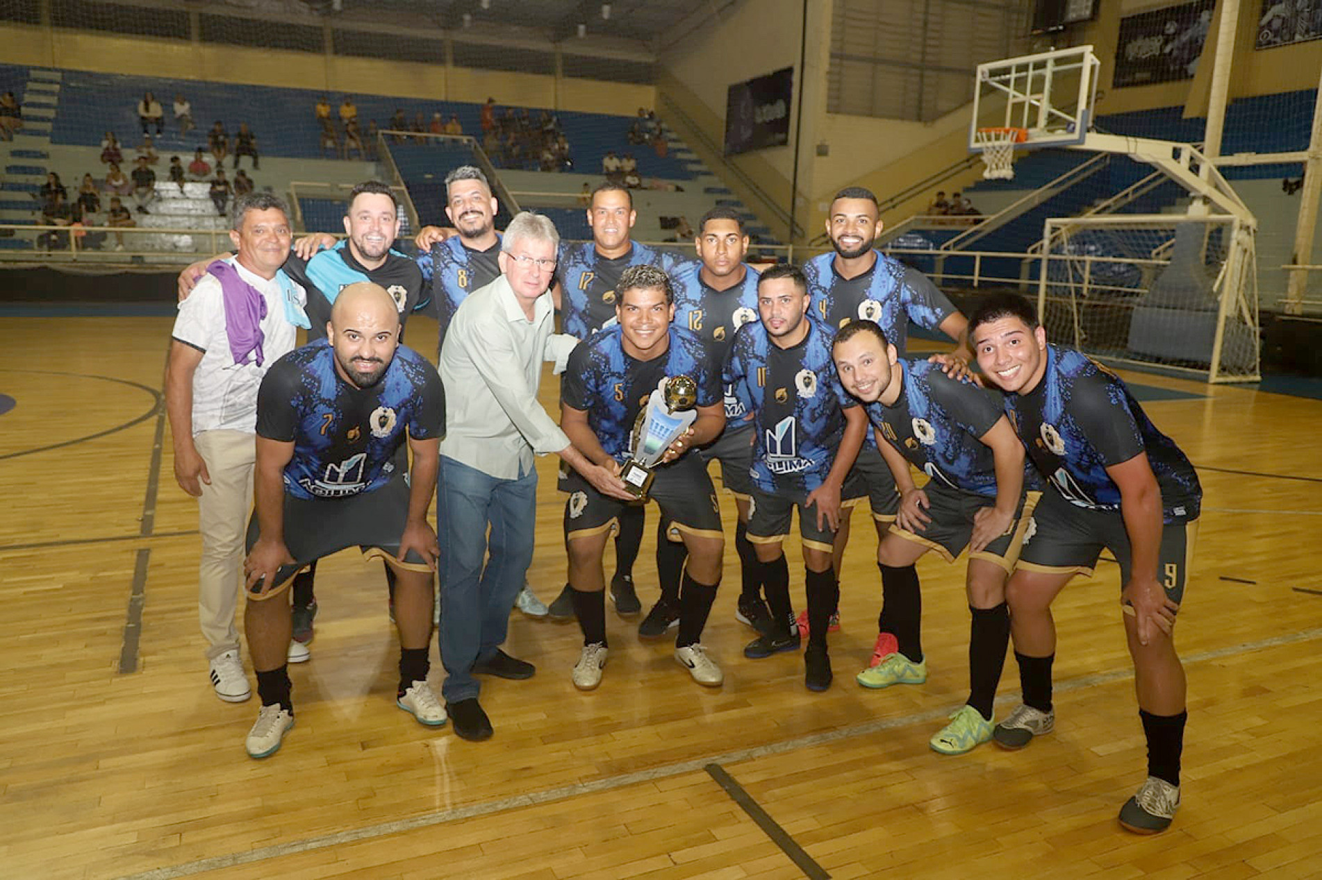 Presidente da diretoria executiva da FUA, H&eacute;lio Sola Aro, entrega trof&eacute;u transit&oacute;rio para a equipe vencedora do primeiro jogo